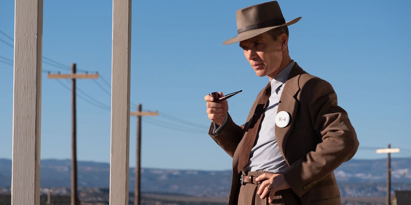 Cillian Murphy as Oppenheimer smoking from a pipe while wearing a suit in Oppenheimer 